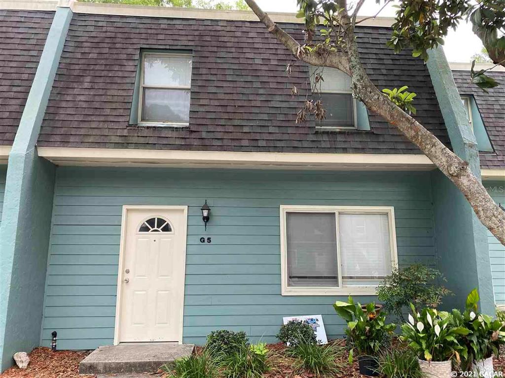 501 Southwest 75th Street, Unit G5 Gainesville, FL 32607 - Photo 1 of 1 a front view of a house with plants