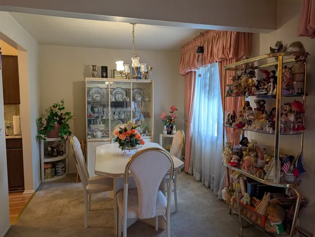 a view of a dining room with furniture and clothes
