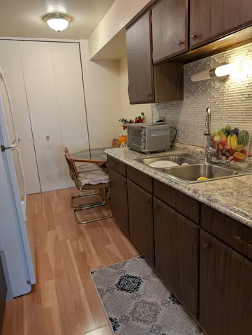 a kitchen with sink refrigerator and cabinets