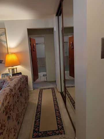 a bedroom with a bed and a lamp