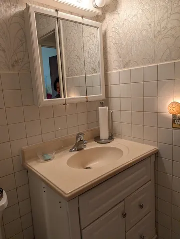 a bathroom with a sink and a mirror