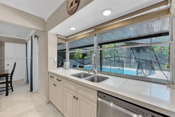 a kitchen with a sink and large window