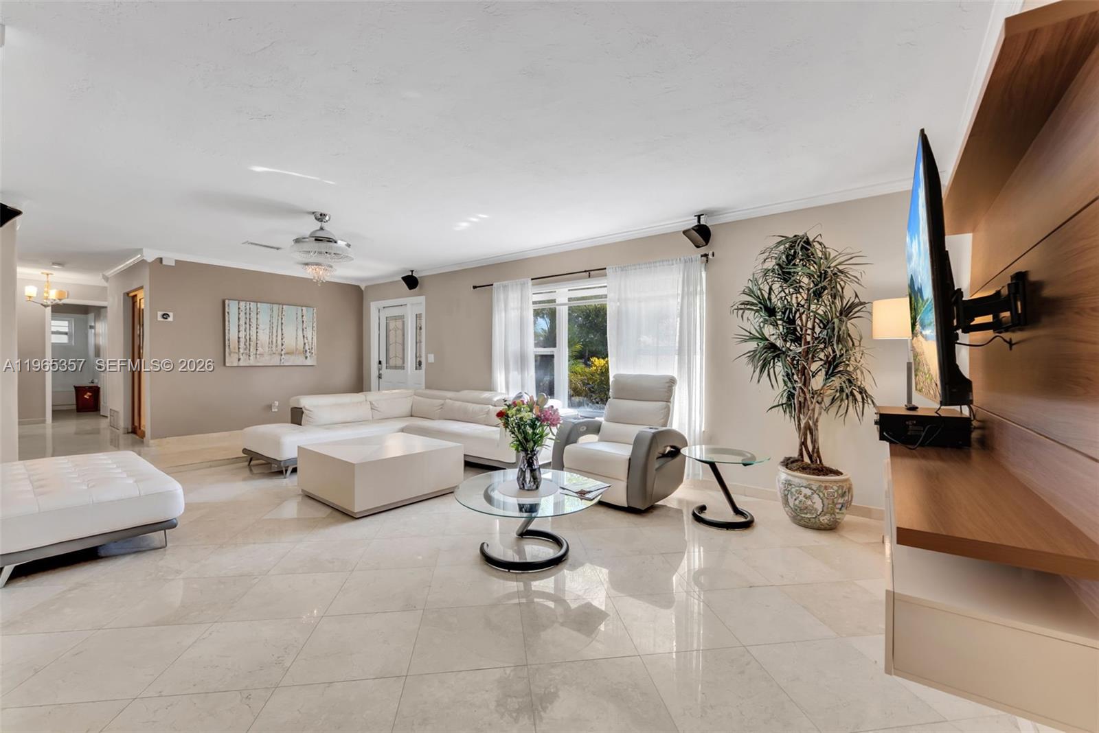 11201 Southwest 136th Street Miami, FL 33176 - Photo 13 of 40 a living room with patio furniture and a flat screen tv