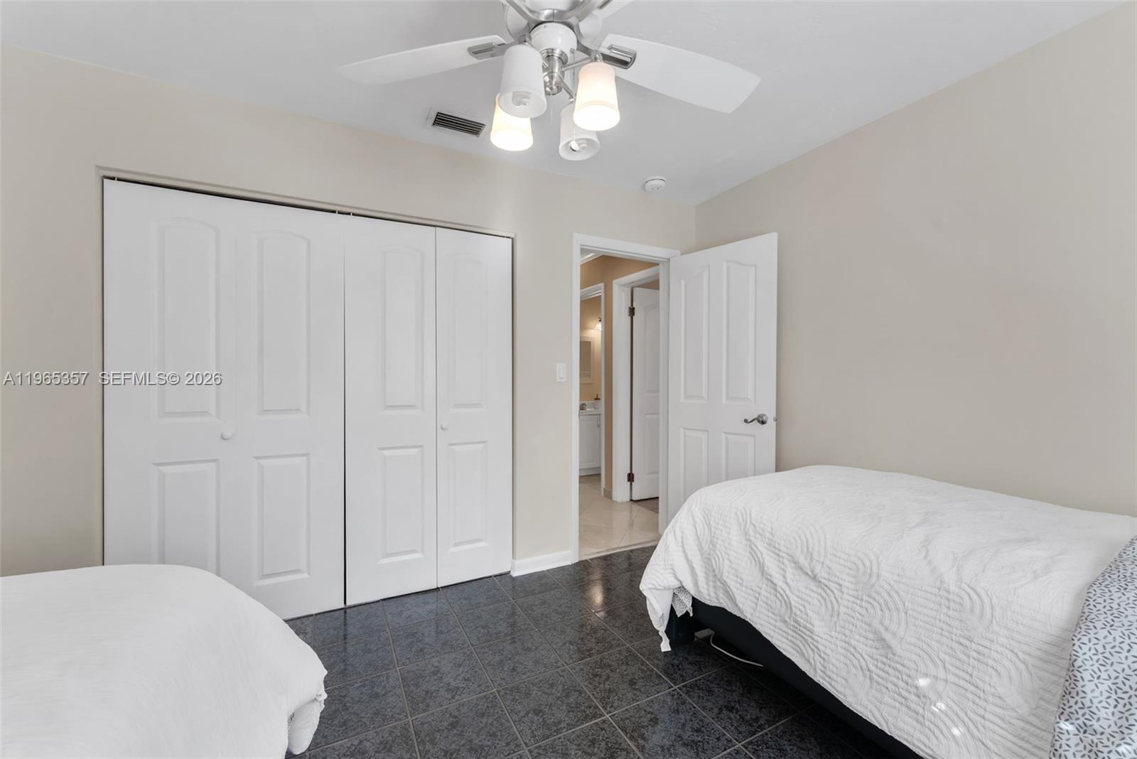 11201 Southwest 136th Street Miami, FL 33176 - Photo 18 of 40 a bedroom with a bed and a chandelier