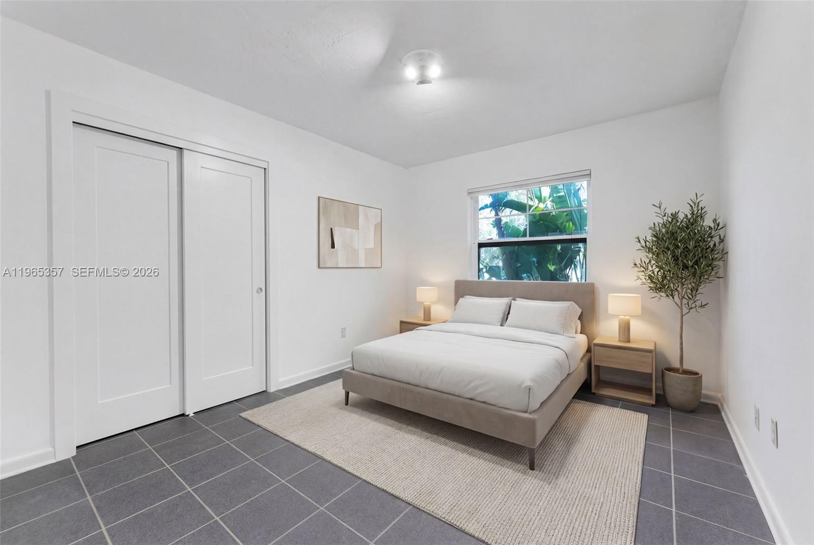 11201 Southwest 136th Street Miami, FL 33176 - Photo 20 of 40 a room with a bed and a potted plant