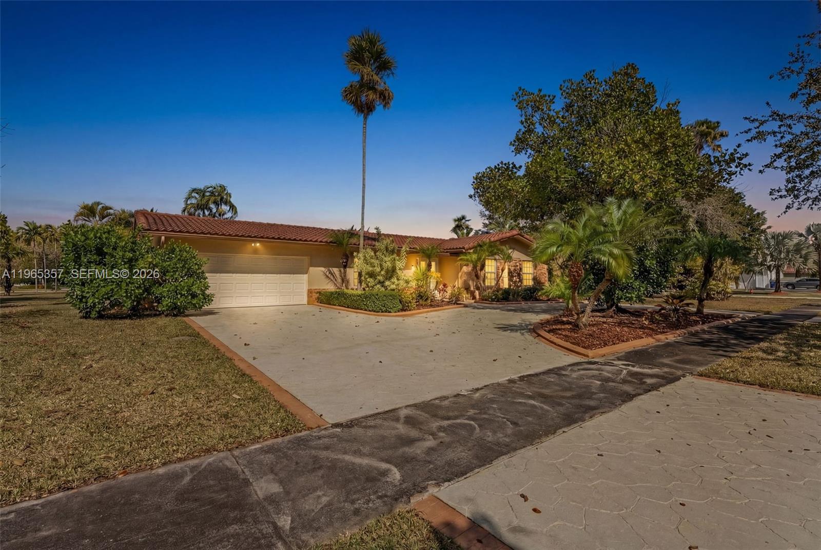 11201 Southwest 136th Street Miami, FL 33176 - Photo 2 of 40 a front view of a house with a yard