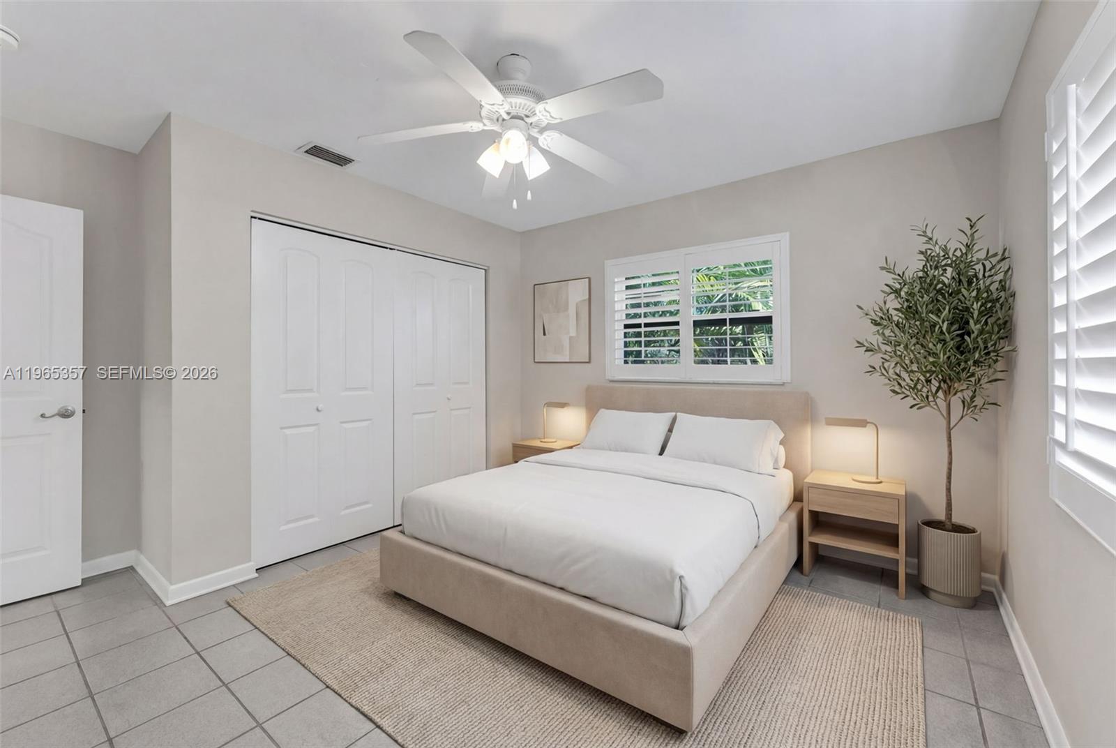 11201 Southwest 136th Street Miami, FL 33176 - Photo 21 of 40 a spacious bedroom with a bed and a chandelier