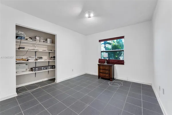 a kitchen with granite countertop a rug a stove and a window