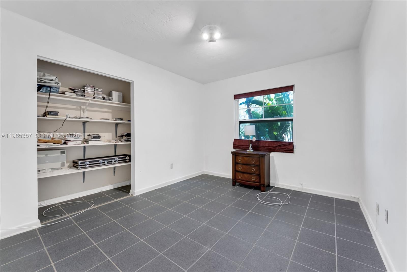 11201 Southwest 136th Street Miami, FL 33176 - Photo 22 of 40 a kitchen with granite countertop a rug a stove and a window