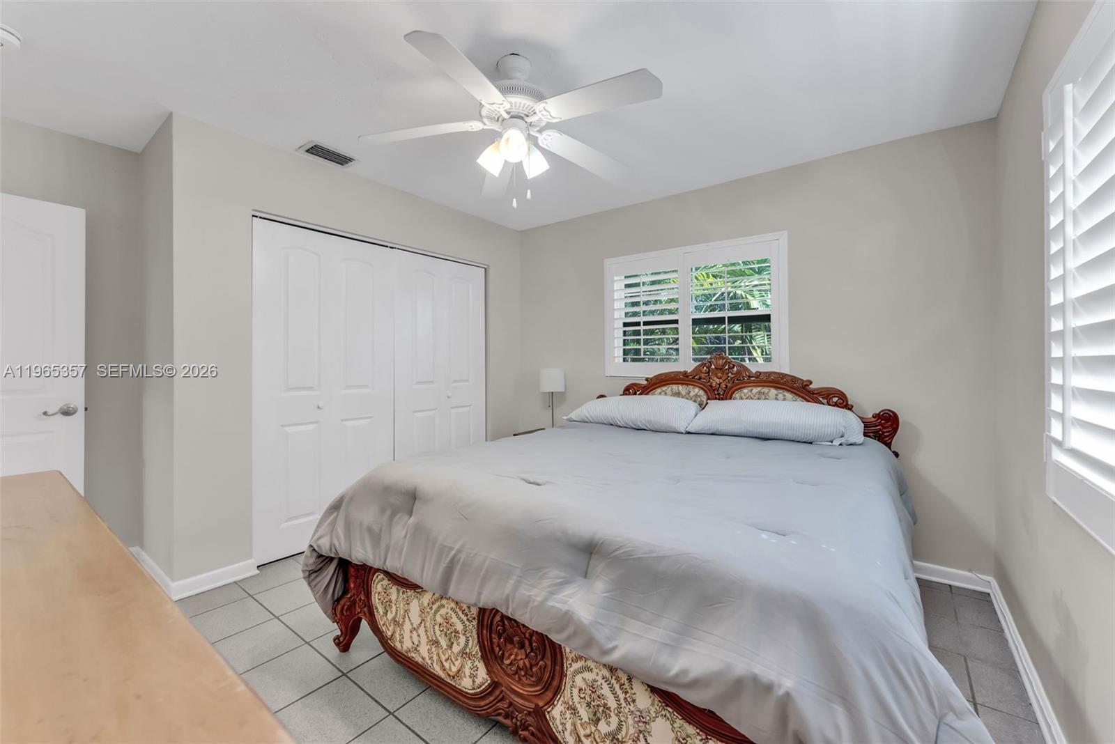 11201 Southwest 136th Street Miami, FL 33176 - Photo 23 of 40 a bed room with a bed and a window