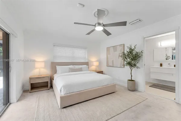 a bedroom with a large bed and a chandelier