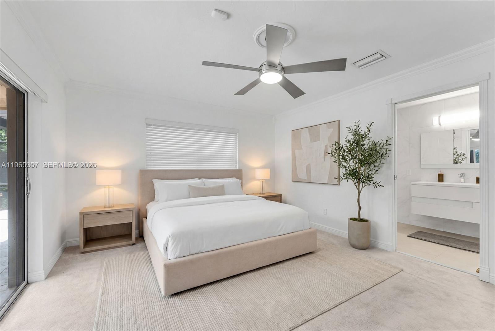 11201 Southwest 136th Street Miami, FL 33176 - Photo 26 of 40 a bedroom with a large bed and a chandelier