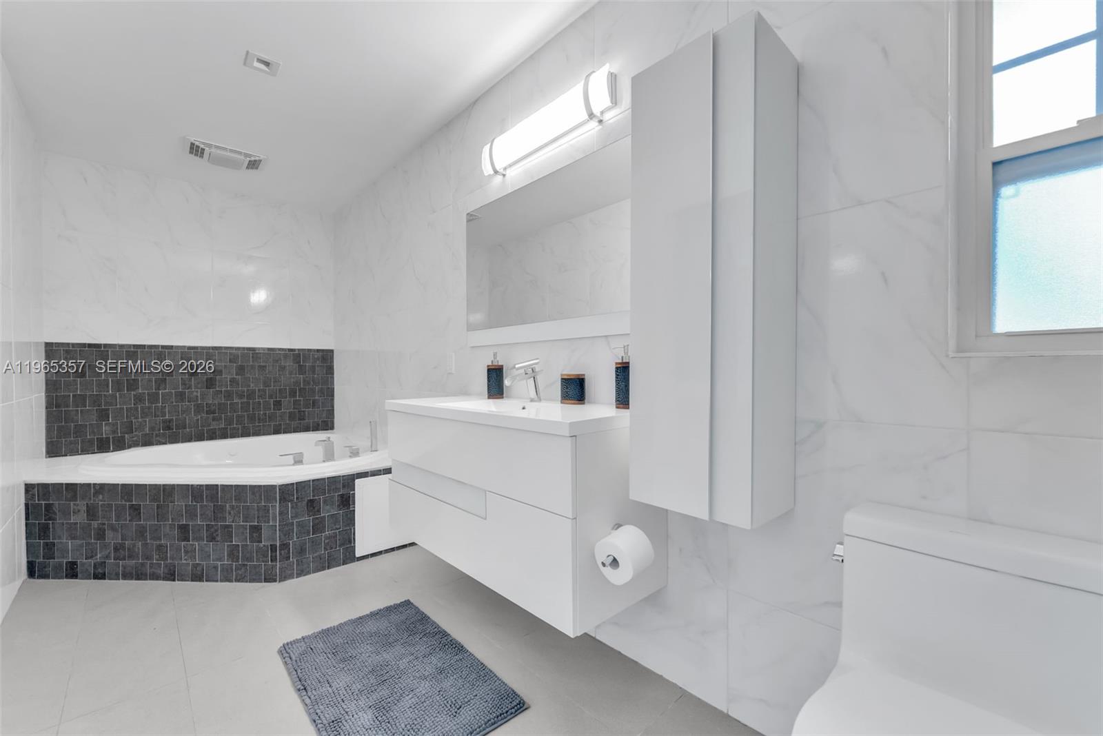 11201 Southwest 136th Street Miami, FL 33176 - Photo 28 of 40 a bathroom with a tub a sink and a mirror