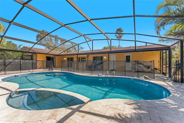 a view of a backyard with swimming pool