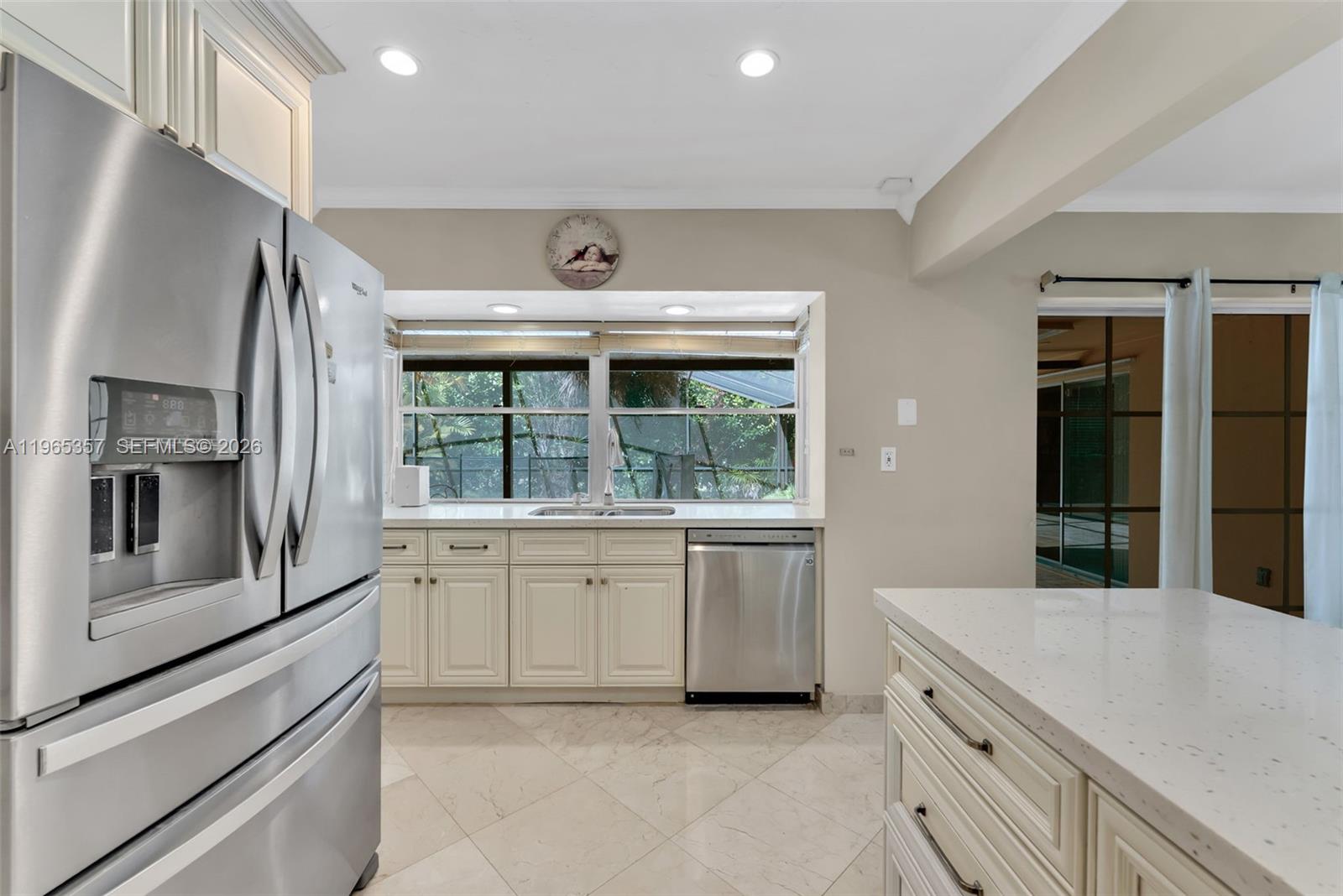 11201 Southwest 136th Street Miami, FL 33176 - Photo 10 of 40 a kitchen with a refrigerator and a sink