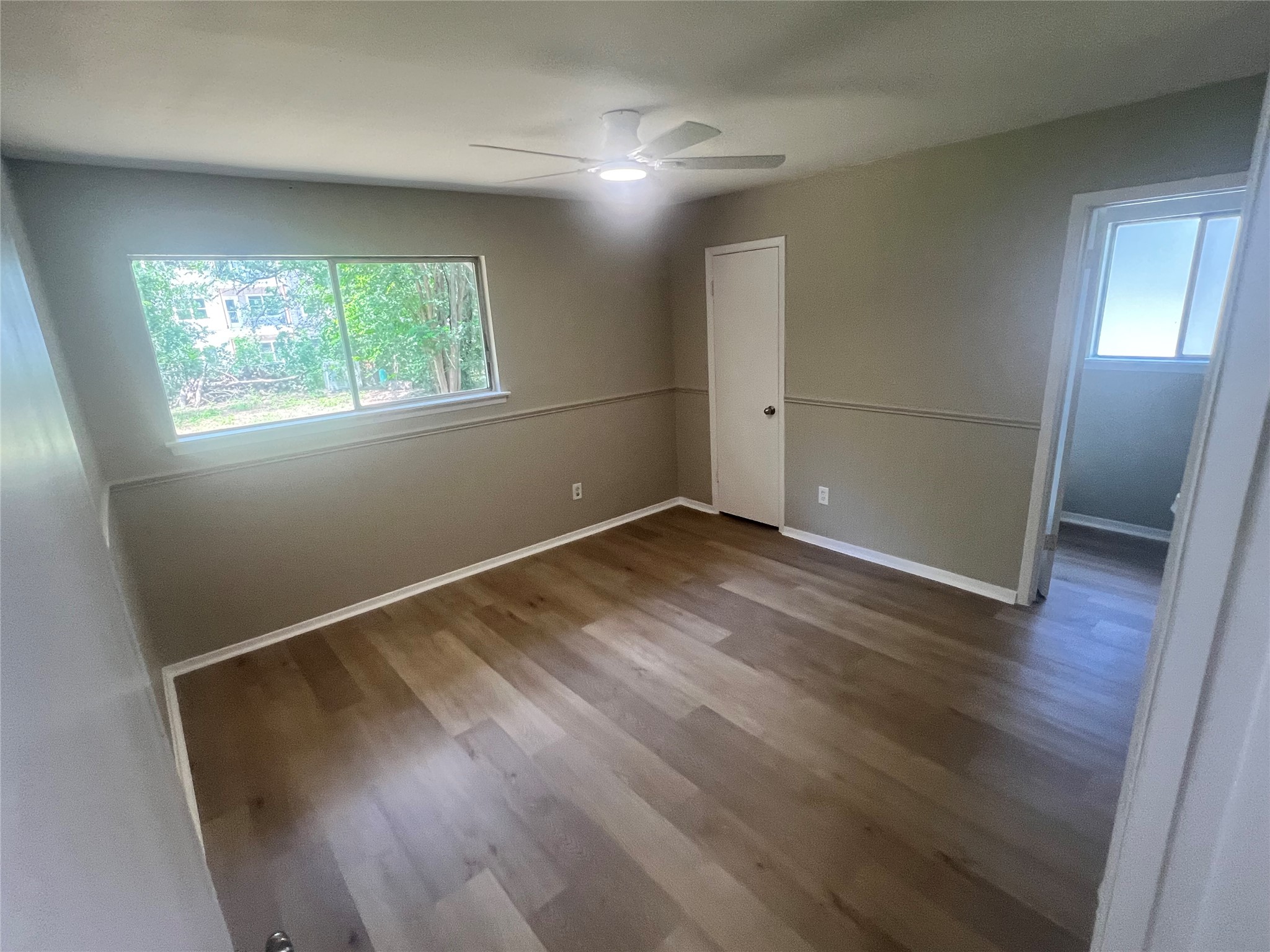 4620 Button Bend Road Austin, TX 78744 - Photo 9 of 22 A quiet bedroom with robust wood flooring and abundant natural light.