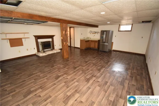 a view of kitchen and hall with wooden floor