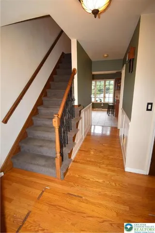 a view of entryway and hall with wooden floor