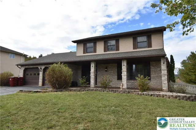 front view of a house with a yard