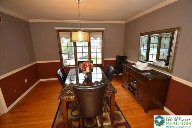 a dining room with furniture and window