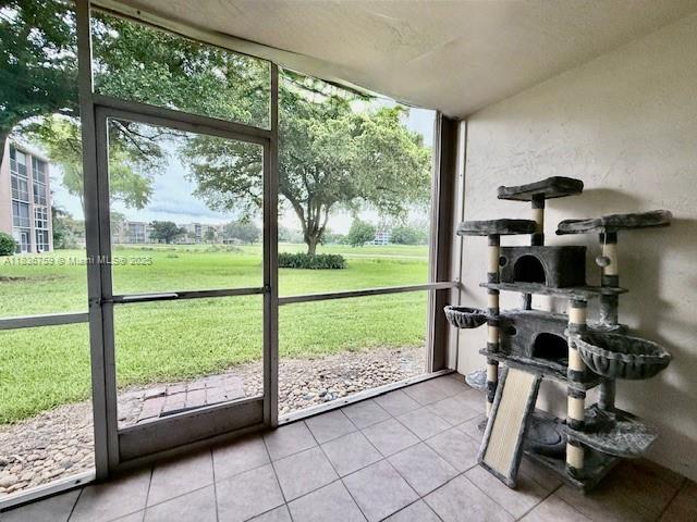 9491 Evergreen Place, Unit 102 Davie, FL 33324 - Photo 11 of 30 a view of a room with gym equipment and large windows