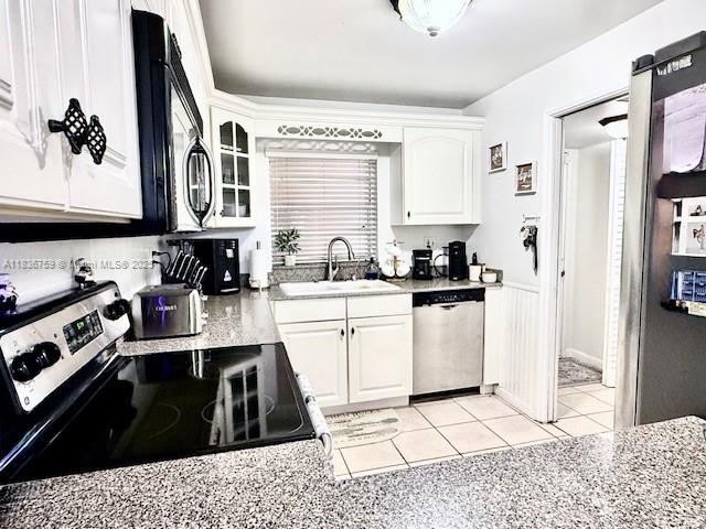 9491 Evergreen Place, Unit 102 Davie, FL 33324 - Photo 18 of 30 a kitchen with a sink a stove and cabinets