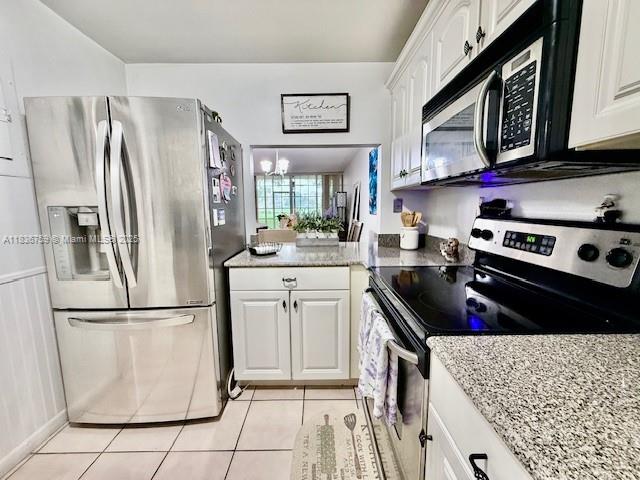 9491 Evergreen Place, Unit 102 Davie, FL 33324 - Photo 21 of 30 a kitchen with stainless steel appliances granite countertop a refrigerator stove and sink