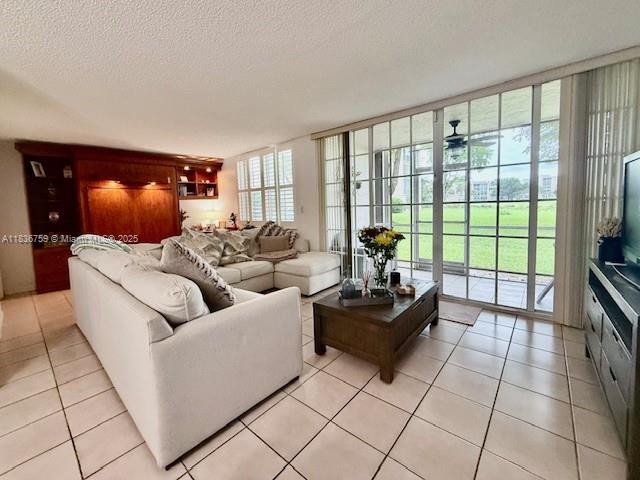 9491 Evergreen Place, Unit 102 Davie, FL 33324 - Photo 4 of 30 a living room with furniture and a floor to ceiling window