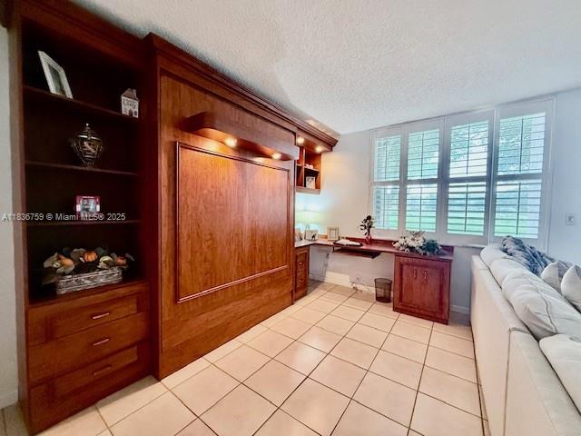 9491 Evergreen Place, Unit 102 Davie, FL 33324 - Photo 7 of 30 a kitchen with stainless steel appliances kitchen island granite countertop a refrigerator and a wooden cabinets