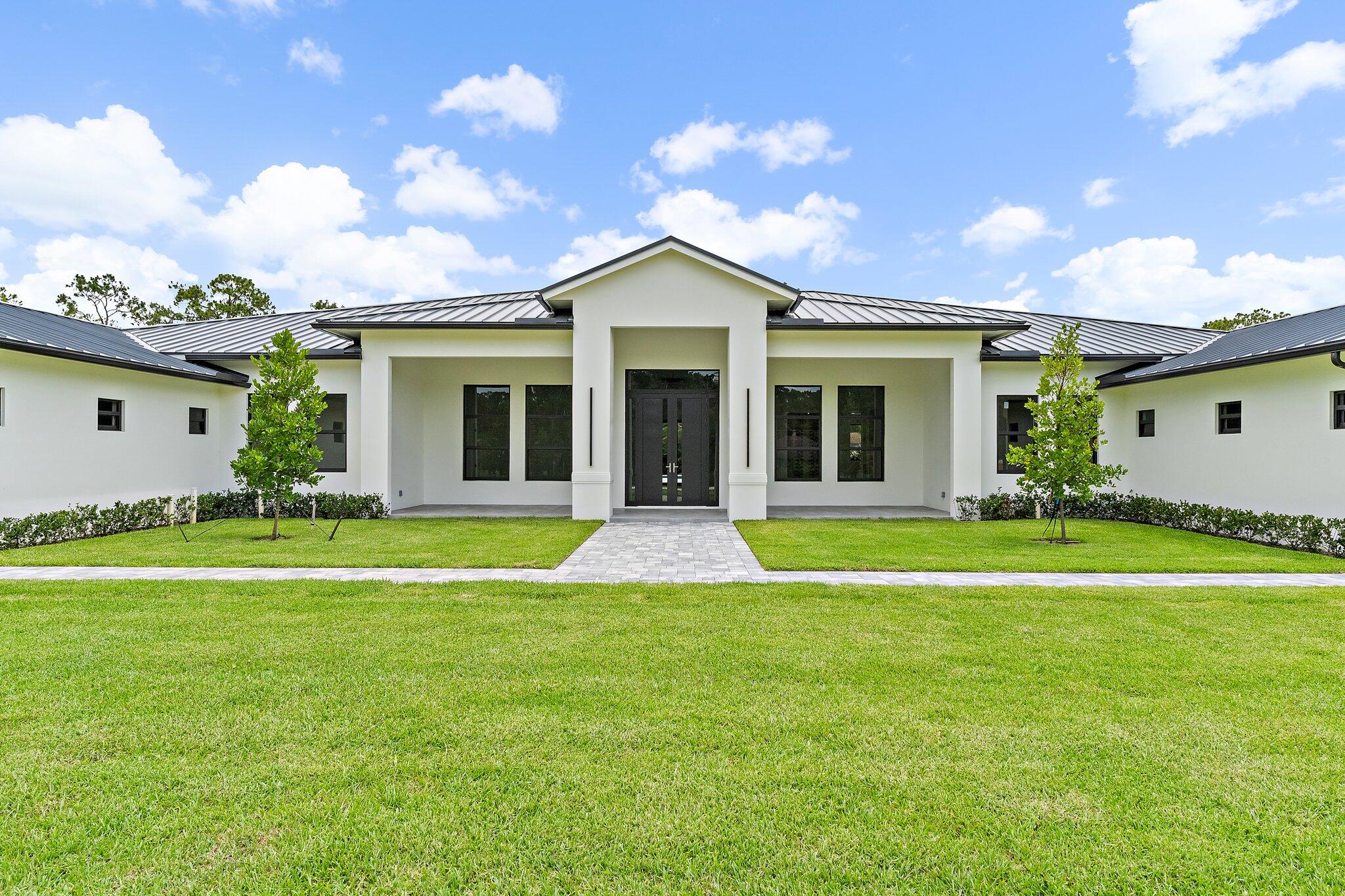 12850 152nd Street North Jupiter, FL 33478 - Photo 11 of 117 a view of a house with a backyard