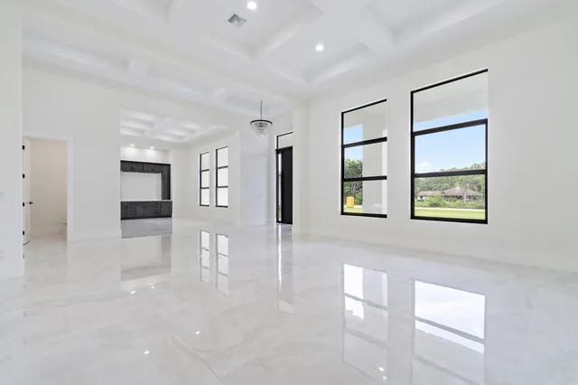 a large kitchen with stainless steel appliances kitchen island granite countertop a sink and cabinets