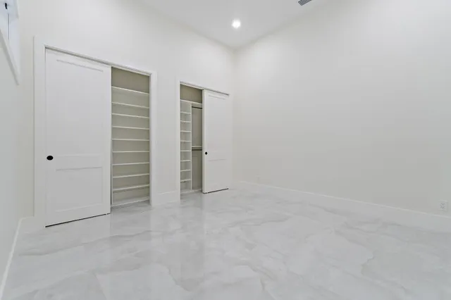 a dining room with furniture a chandelier and glass door