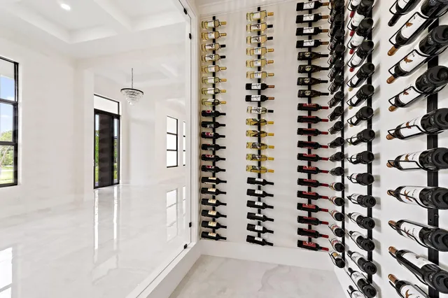 a bathroom with white cabinets sink and mirror