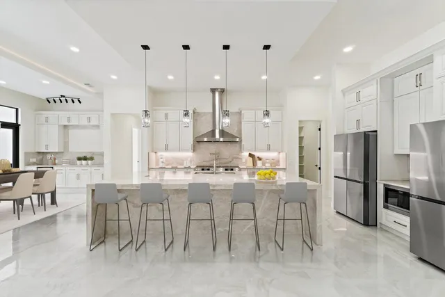a view of a house with swimming pool and sitting area