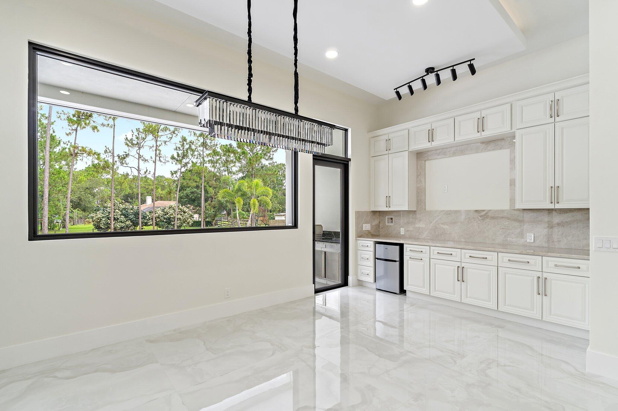 12850 152nd Street North Jupiter, FL 33478 - Photo 47 of 117 a kitchen with stainless steel appliances granite countertop a stove a sink and a refrigerator