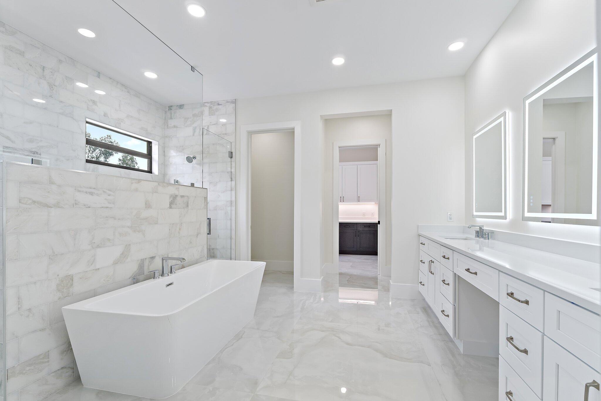 12850 152nd Street North Jupiter, FL 33478 - Photo 53 of 117 a spacious bathroom with a bathtub sink and mirror