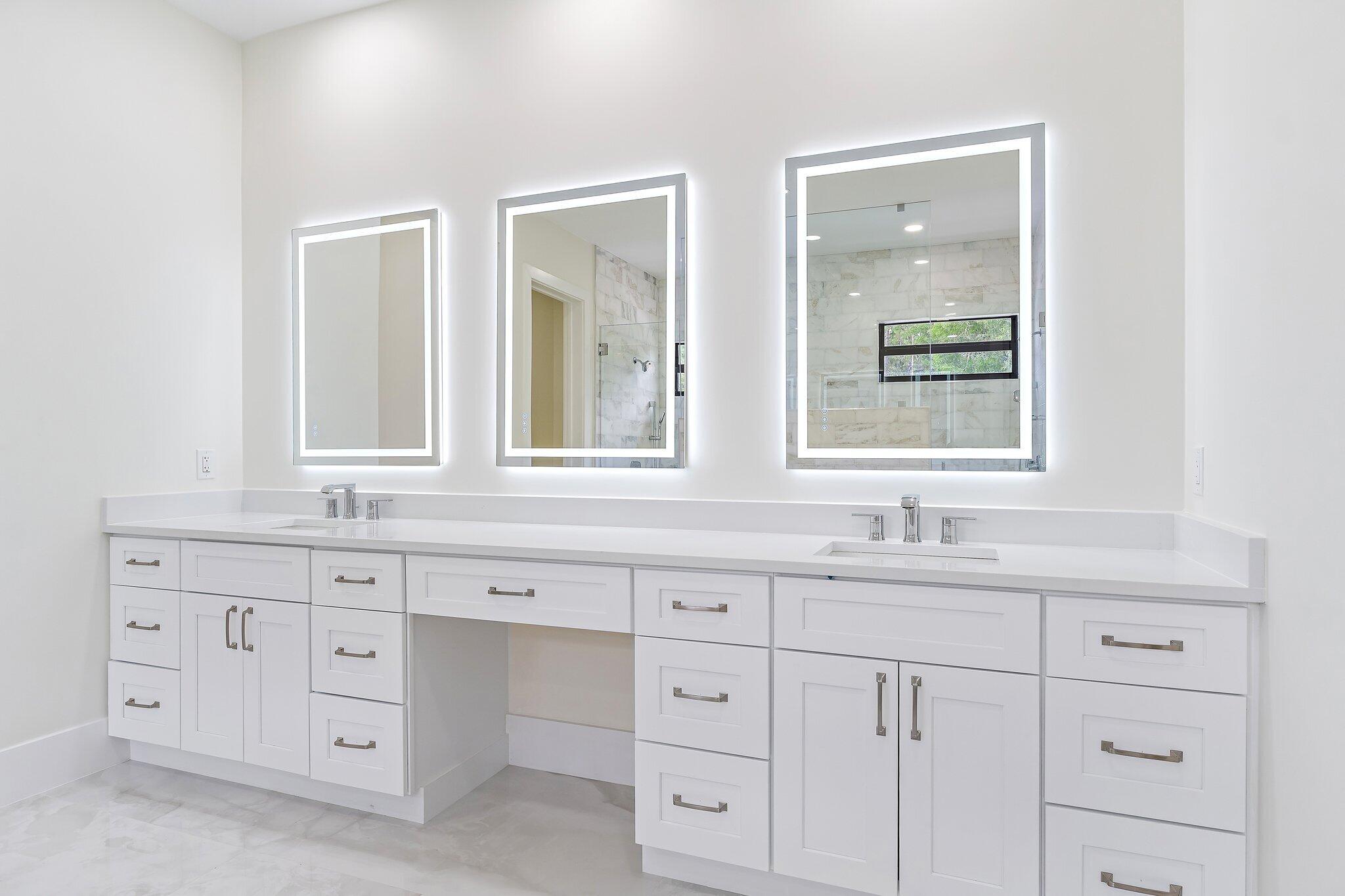 12850 152nd Street North Jupiter, FL 33478 - Photo 54 of 117 a bathroom with white cabinets sink and mirror