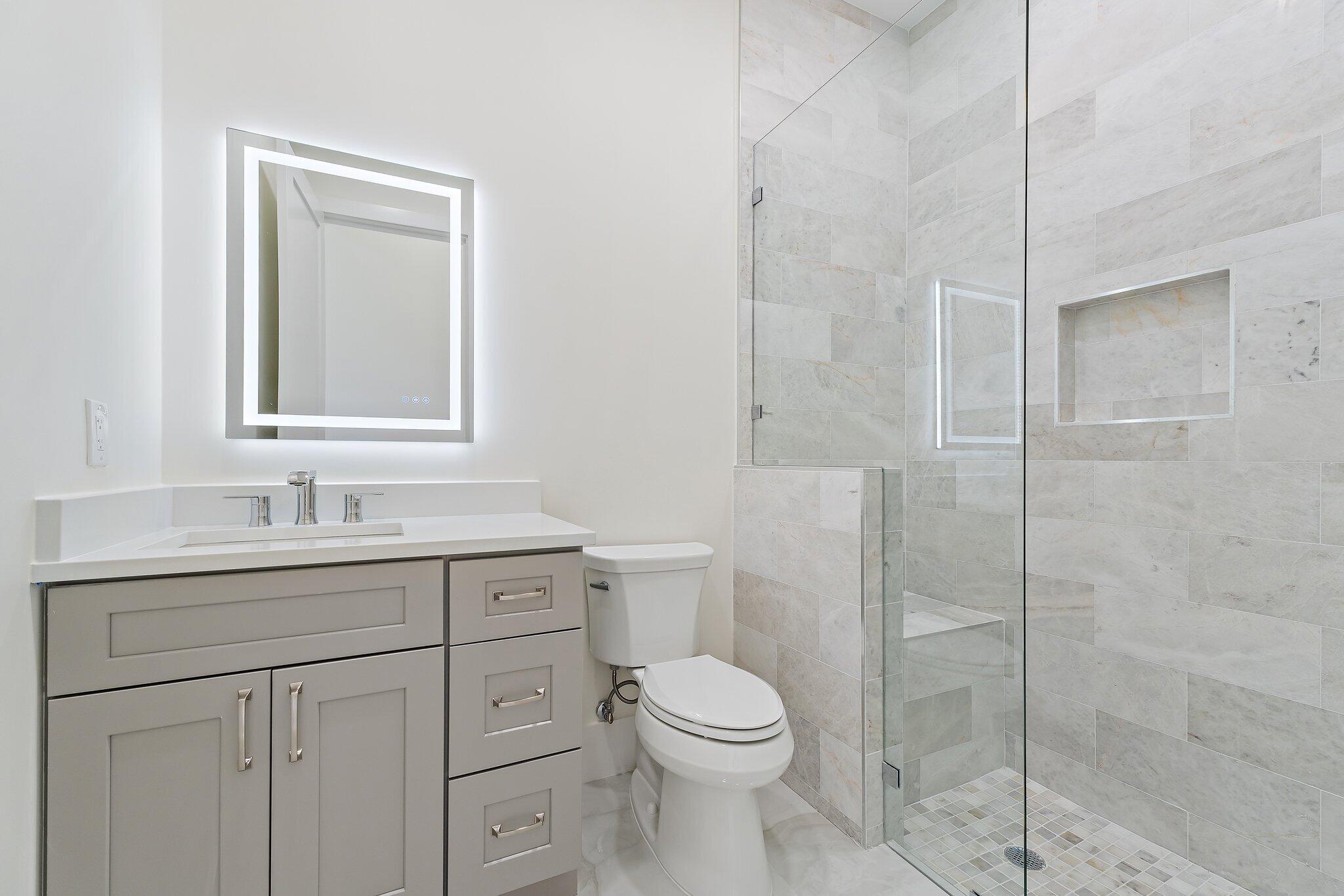 12850 152nd Street North Jupiter, FL 33478 - Photo 59 of 117 a bathroom with a toilet sink vanity and granite