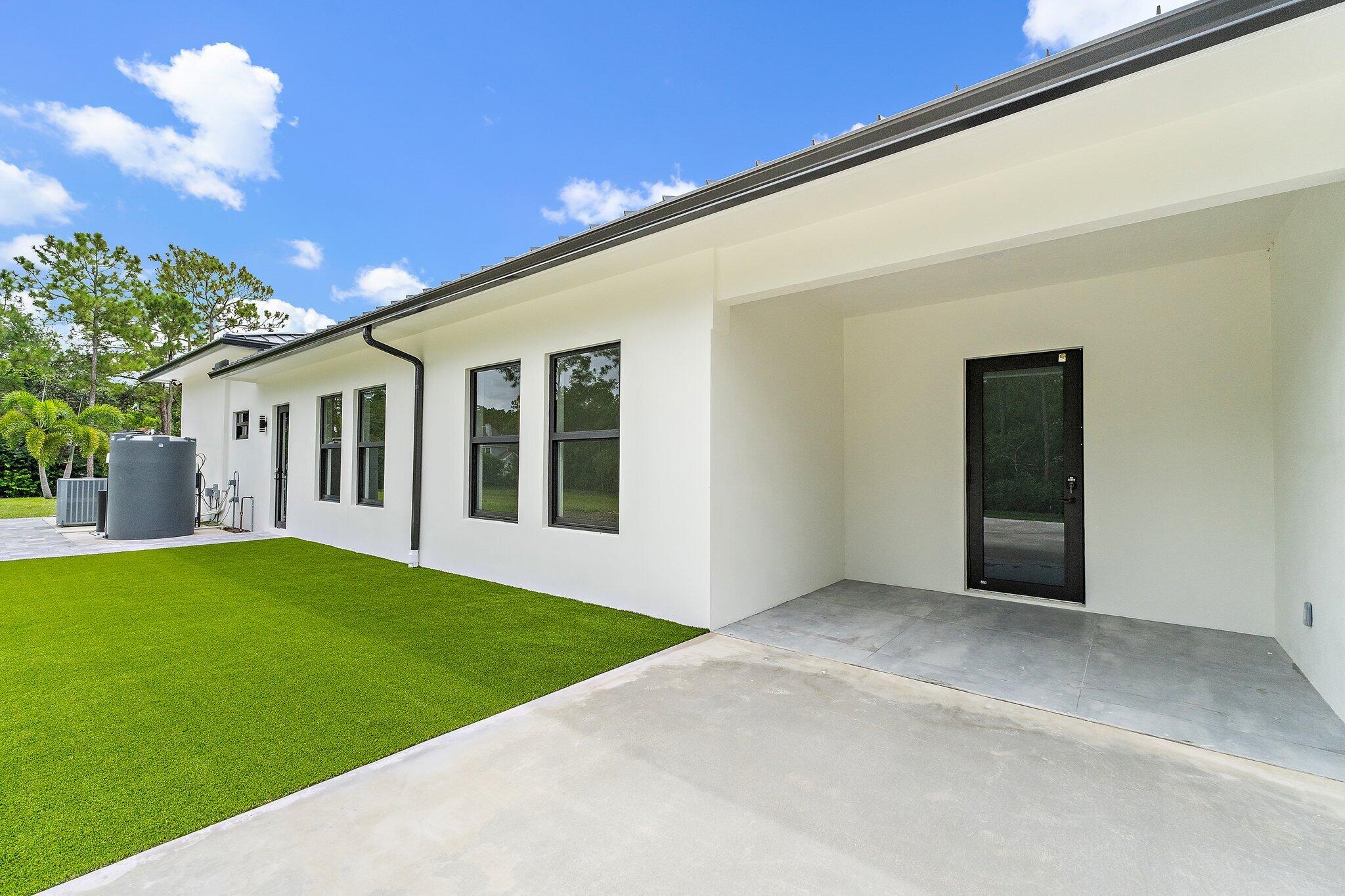 12850 152nd Street North Jupiter, FL 33478 - Photo 91 of 117 a view of an house with backyard porch and garden