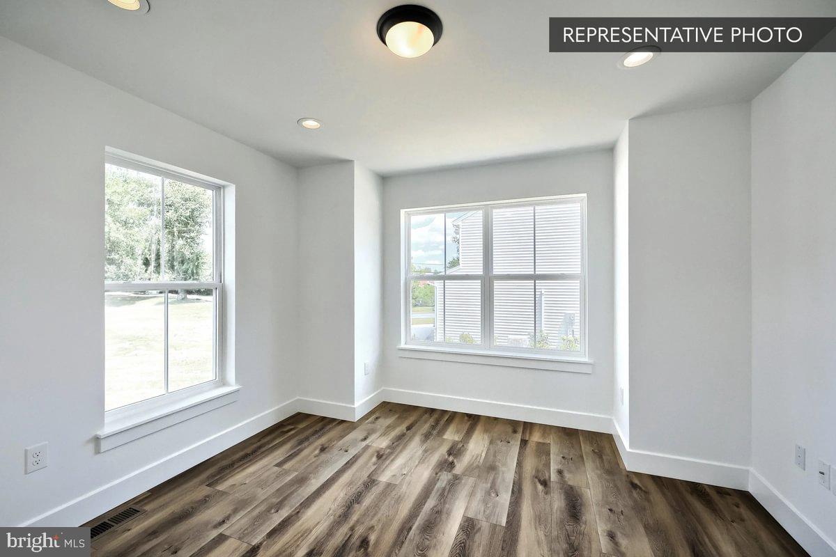 Emily Plan At The Seasons Dover, PA 17315 - Photo 6 of 27 a view of an empty room with wooden floor and a window