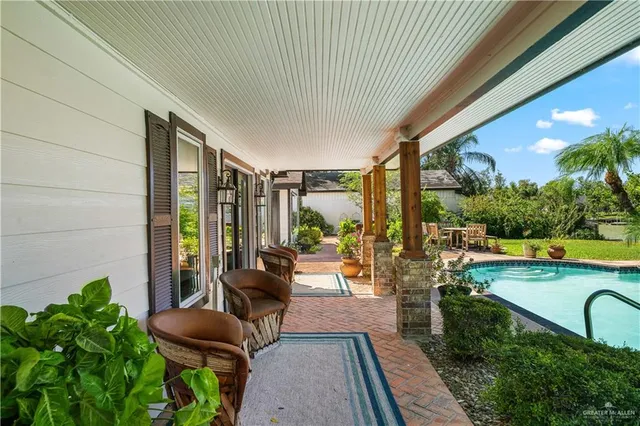 a living room with patio furniture and a swimming pool