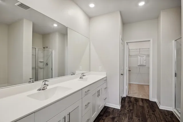 a bathroom with a double vanity sink a and mirror