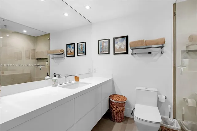 a bathroom with a toilet a sink and mirror