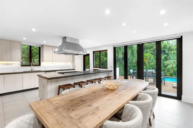 a large kitchen with a table and chairs