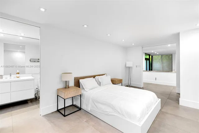 a spacious bedroom with a bed and a table