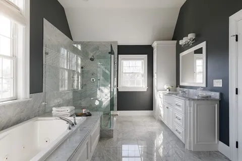 a spacious bathroom with a granite countertop tub sink a mirror a vanity and a shower