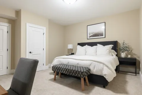 a bedroom with a bed and a chair