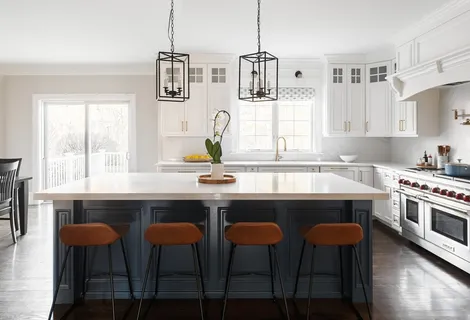 a kitchen with stainless steel appliances a dining table chairs and window