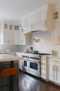 a stove top oven sitting inside of a kitchen