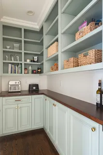 a kitchen with stainless steel appliances white cabinets and a sink